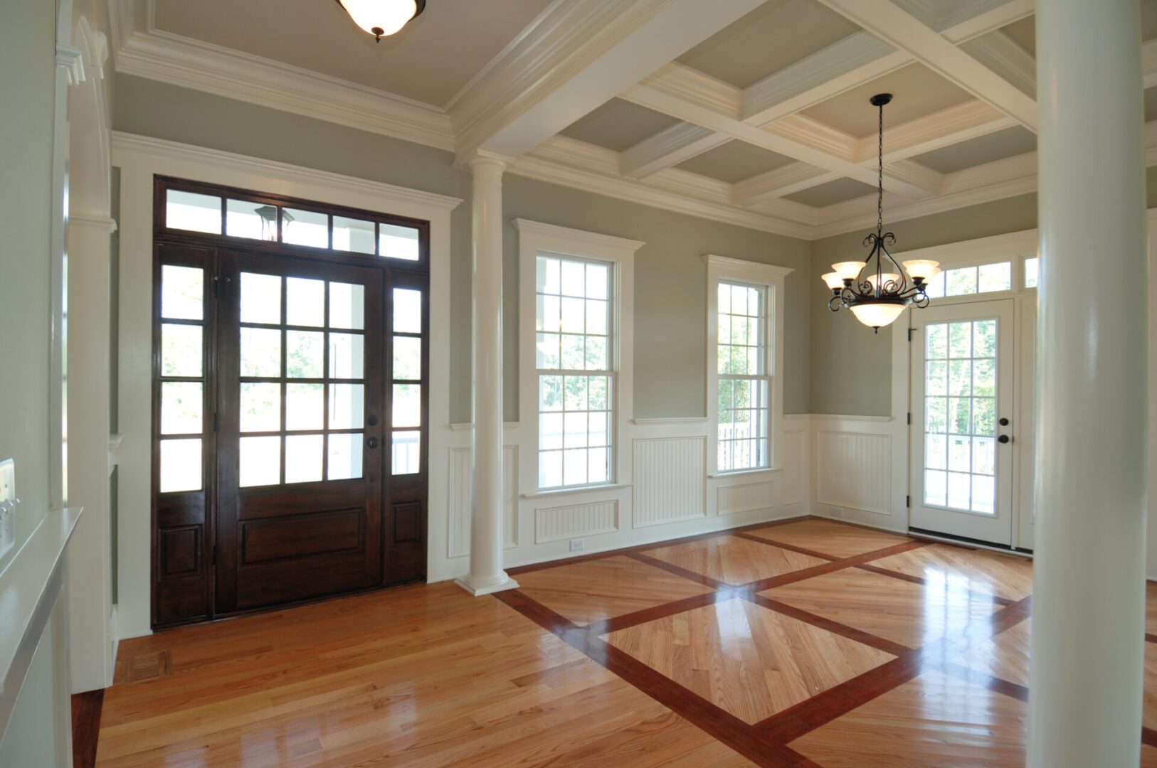 Elegant room with wooden floors and chandelier.