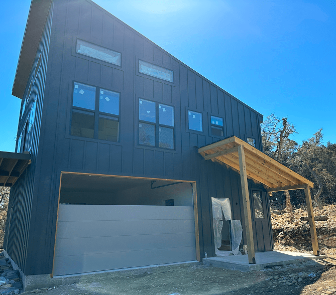 Modern two-story house under clear sky.