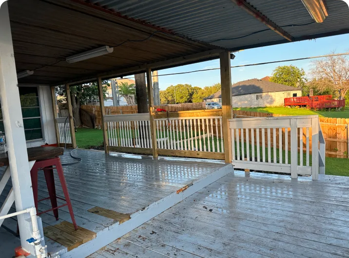 Covered patio with white wooden floor.