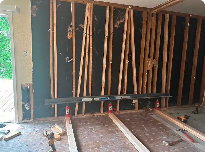 Room under construction with exposed wooden studs.
