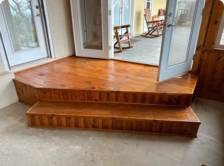 Wooden steps leading to open patio doors.